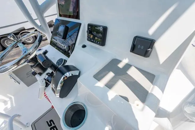Slide: The Image of 2025 Sea Pro 250 Bay boat console with modern controls and navigation equipment. - 19