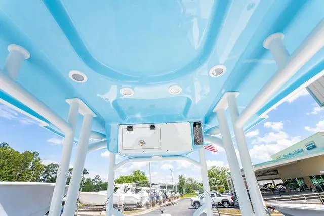 Slide: The Image of 2025 Sea Pro 250 Bay boat, blue T-top, outdoor dealership display. - 20