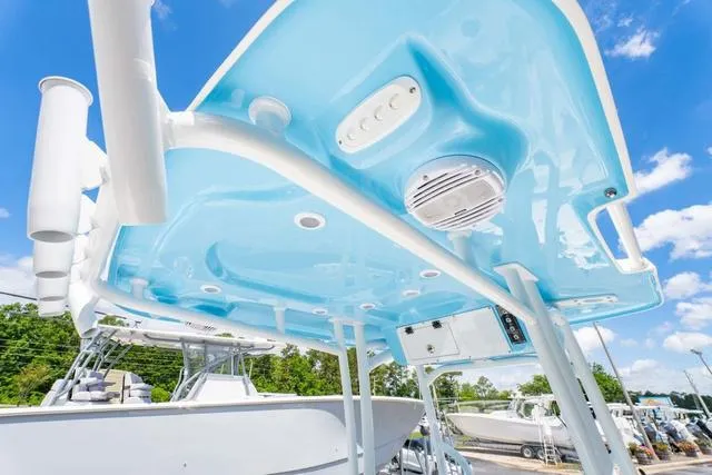 Slide: The Image of 2025 Sea Pro 250 Bay boat, featuring a sleek blue canopy and modern design elements. - 21