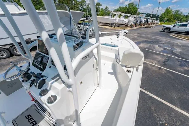 Slide: The Image of 2025 Sea Pro 250 Bay boat with modern console and spacious deck in a parking lot. - 22