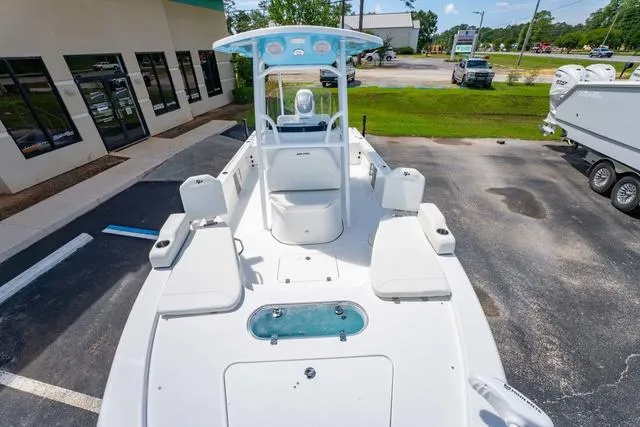 Slide: The Image of 2025 Sea Pro 250 Bay boat, white deck, center console, parked outdoors. - 27