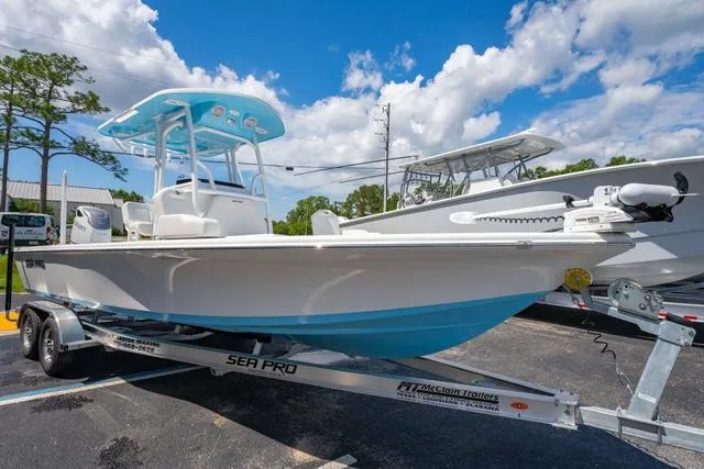 Slide: The Image of 2025 Sea Pro 250 Bay boat on trailer under blue sky. - 7