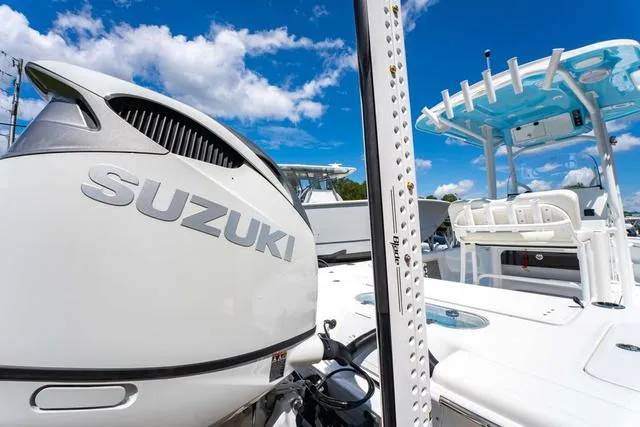 Slide: The Image of 2025 Sea Pro 250 Bay boat with Suzuki engine under clear blue sky. - 9