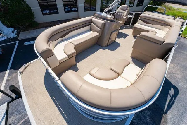 Slide: The Image of 2019 Bennington 20 SX pontoon boat with spacious beige seating and modern interior design. - 10