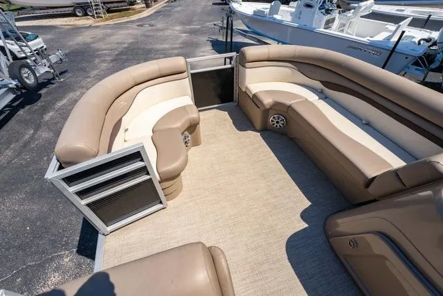 Slide: The Image of 2019 Bennington 20 SX pontoon boat interior with beige seating and carpeted floor. - 11