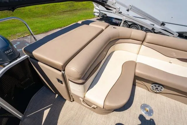 Slide: The Image of 2019 Bennington 20 SX pontoon boat with beige seating and a 90 HP engine. - 14