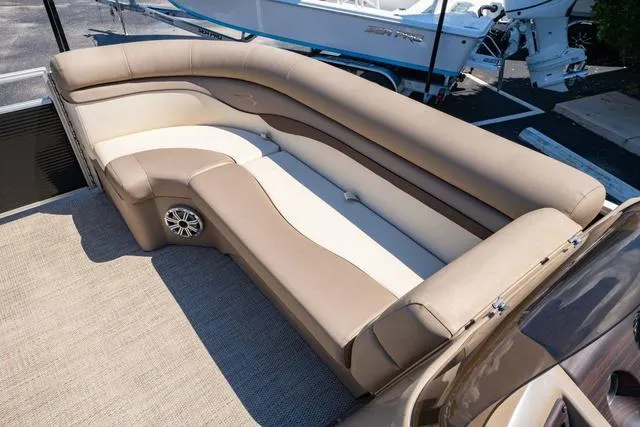 Slide: The Image of 2019 Bennington 20 SX boat interior with beige seating and speaker. - 16