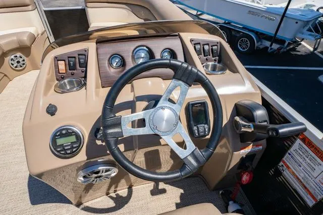 Slide: The Image of 2019 Bennington 20 SX boat dashboard with steering wheel and control panel. - 18