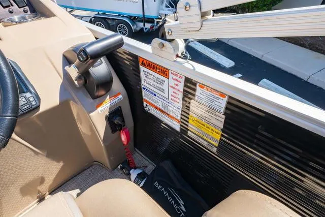 Slide: The Image of 2019 Bennington 20 SX boat cockpit with control panel and safety warnings. - 19