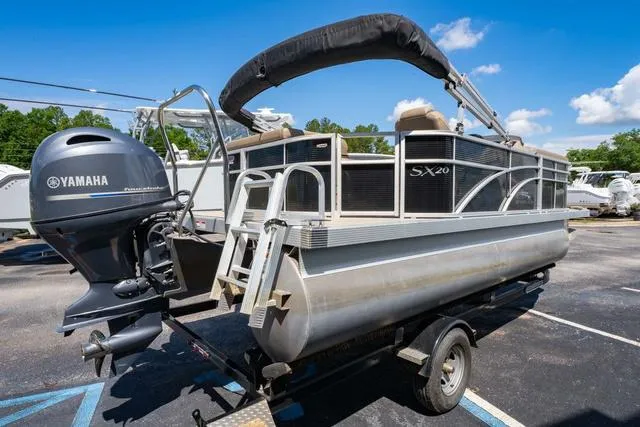 Slide: The Image of 2019 Bennington 20 SX pontoon boat with Yamaha engine on trailer, parked outdoors. - 5