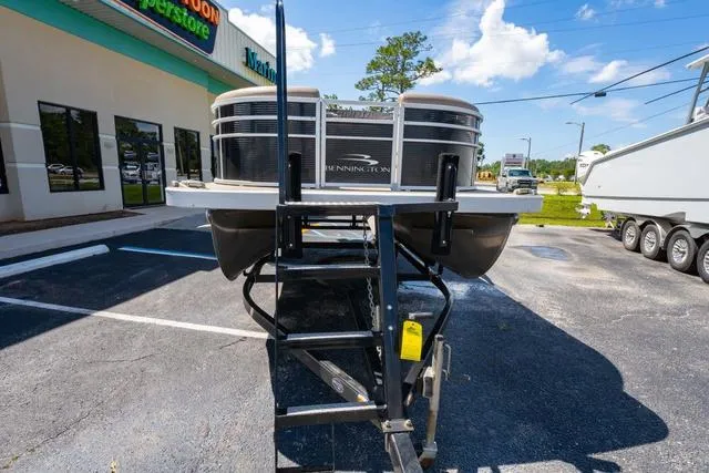 Slide: The Image of 2019 Bennington 20 SX pontoon boat on trailer in parking lot. - 8