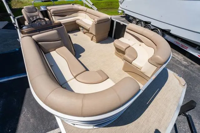 Slide: The Image of 2019 Bennington 20 SX pontoon boat with spacious beige seating and carpeted deck. - 9
