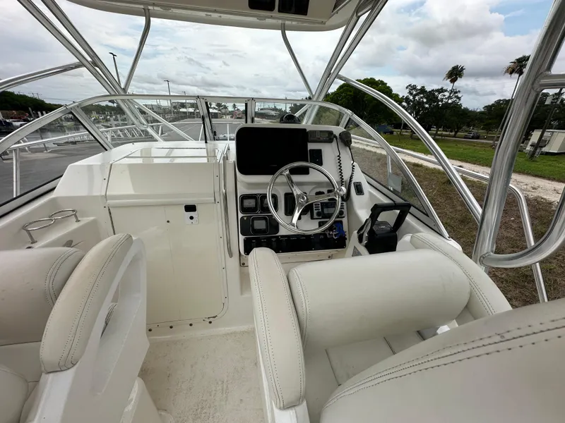 Slide: The Image of 2008 Century 2600 Walkaround boat interior with steering wheel and control panel. - 11