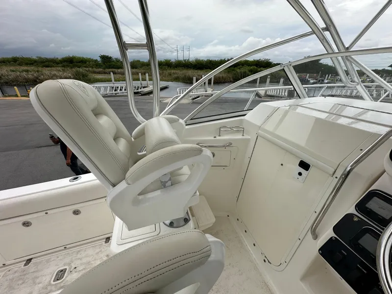 Slide: The Image of 2008 Century 2600 Walkaround boat interior with white seating and control panel. - 12