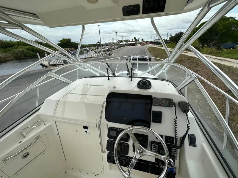 Slide: The Image of 2008 Century 2600 Walkaround boat cockpit with steering wheel and navigation equipment. - 14