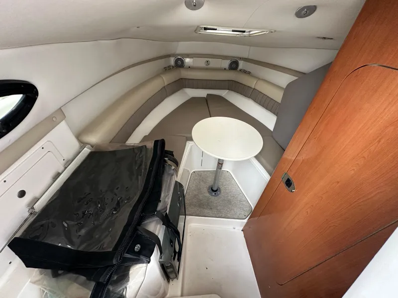 Slide: The Image of Interior of a 2008 Century 2600 Walkaround boat with seating and table. - 18