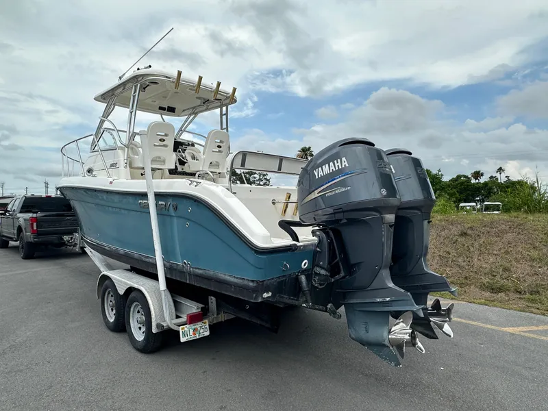 Slide: The Image of 2008 Century 2600 Walkaround boat with dual Yamaha outboard engines on a trailer. - 3