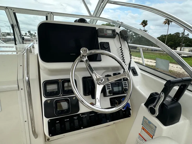 Slide: The Image of Century 2600 Walkaround 2008 boat dashboard with steering wheel and control panel. - 8