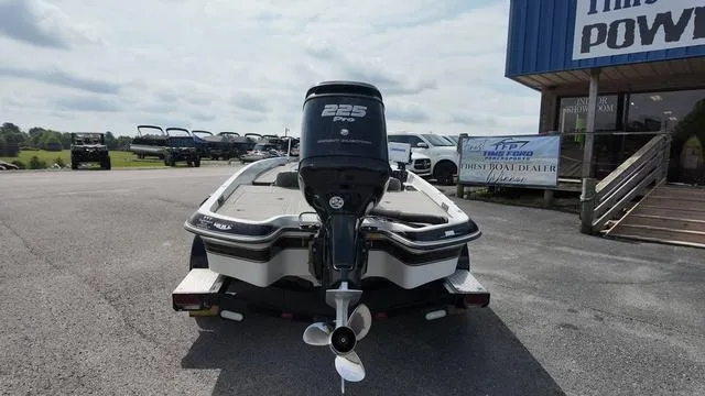 Slide: The Image of 1997 Pro Craft 200 Super Pro boat with 225 HP engine, parked outdoors. - 4