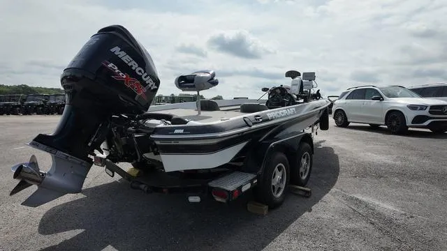 Slide: The Image of 1997 Pro Craft 200 Super Pro boat with Mercury engine in a parking lot. - 5