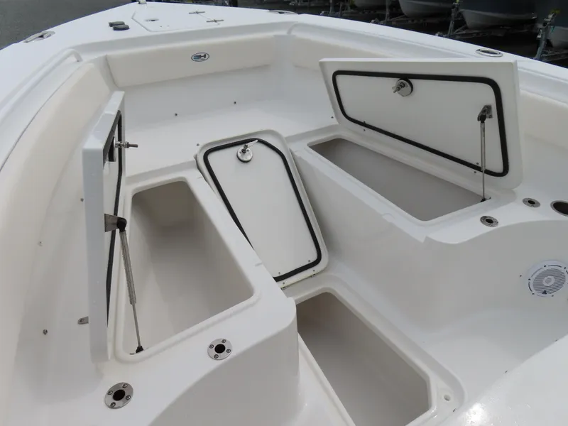 Slide: The Image of 2023 Sea Hunt Gamefish 25 boat storage compartments with open hatches, showcasing spacious interior design. - 10