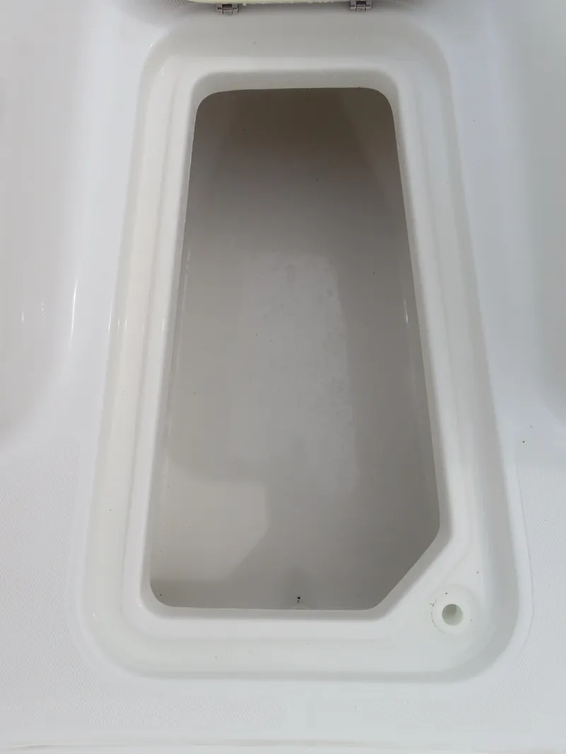 Slide: The Image of Storage compartment of 2023 Sea Hunt Gamefish 25 boat, open and empty. - 11