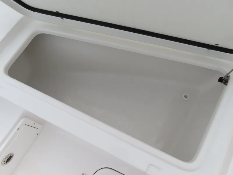 Slide: The Image of 2023 Sea Hunt Gamefish 25 storage compartment, open and empty, showcasing interior space. - 13