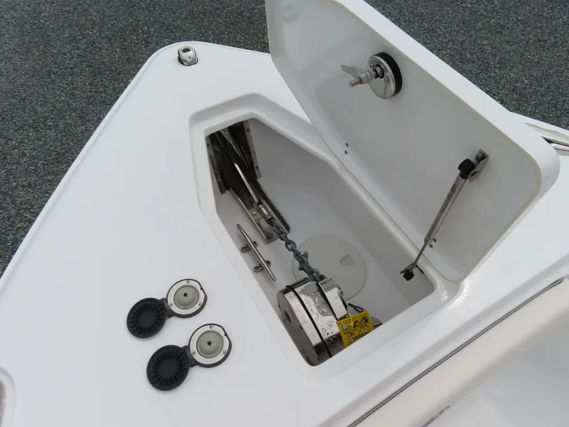 Slide: The Image of 2023 Sea Hunt Gamefish 25 anchor locker with open hatch and chain mechanism. - 16