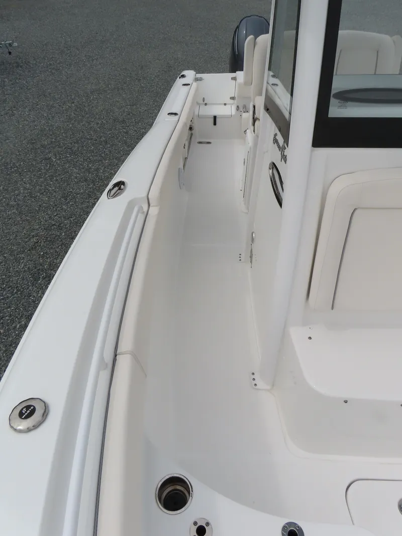 Slide: The Image of 2023 Sea Hunt Gamefish 25 boat deck, featuring sleek white design and spacious layout. - 18