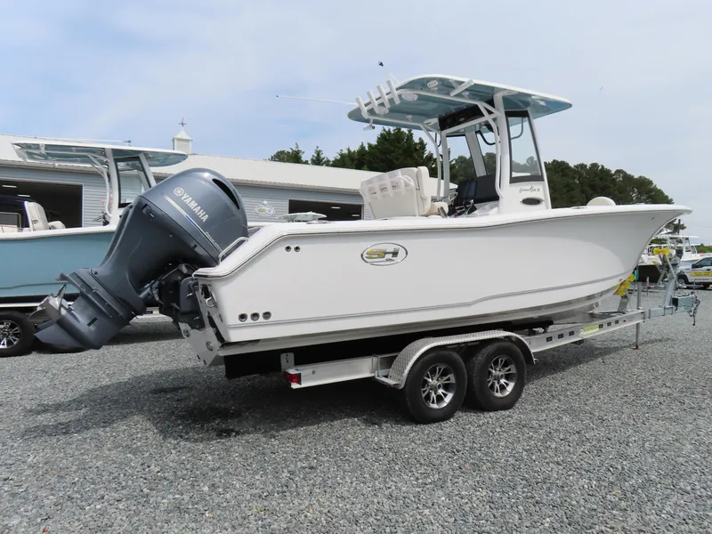 Slide: The Image of 2023 Sea Hunt Gamefish 25 boat on trailer, featuring Yamaha outboard motor. - 2