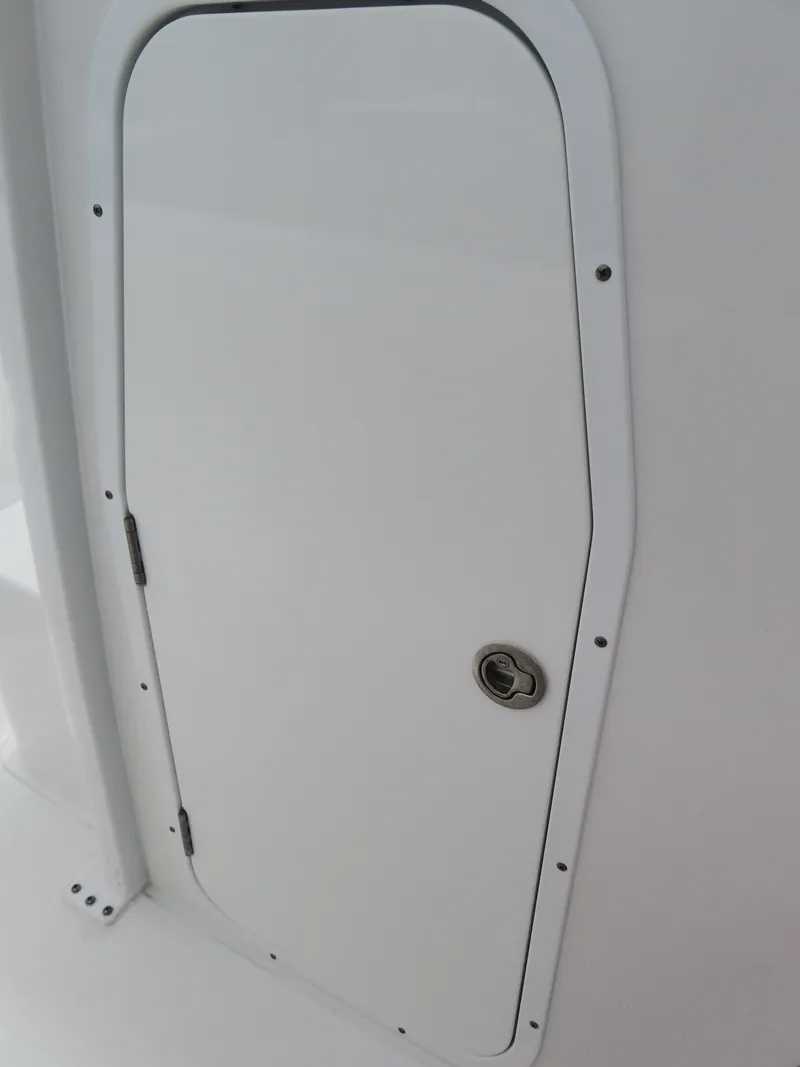 Slide: The Image of 2023 Sea Hunt Gamefish 25 boat hatch door, white with metal handle. - 20