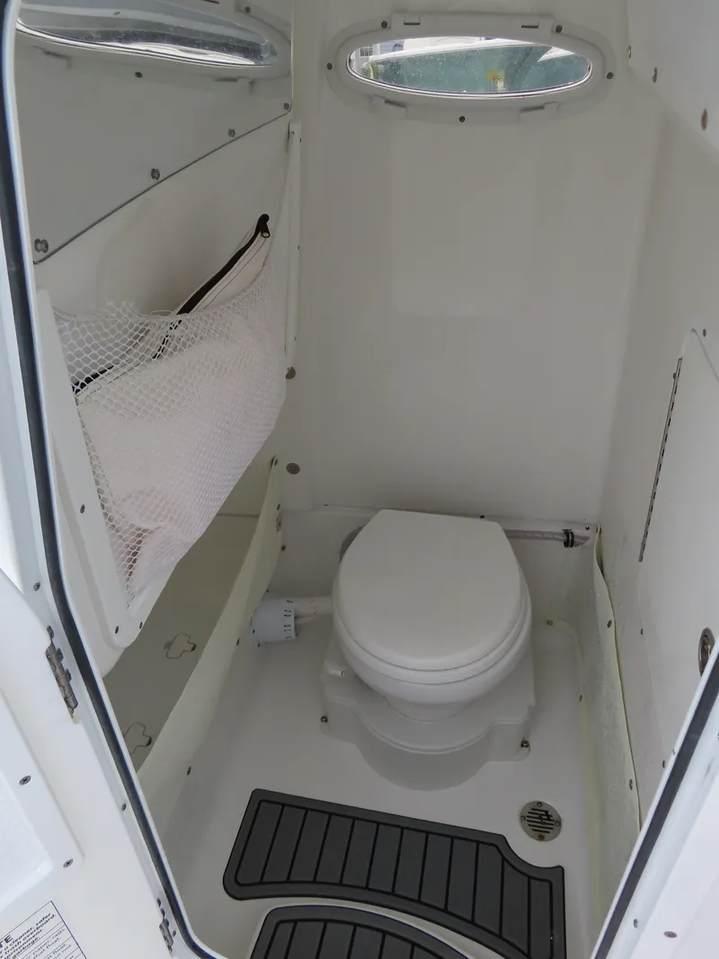 Slide: The Image of 2023 Sea Hunt Gamefish 25 boat interior with compact marine toilet. - 21