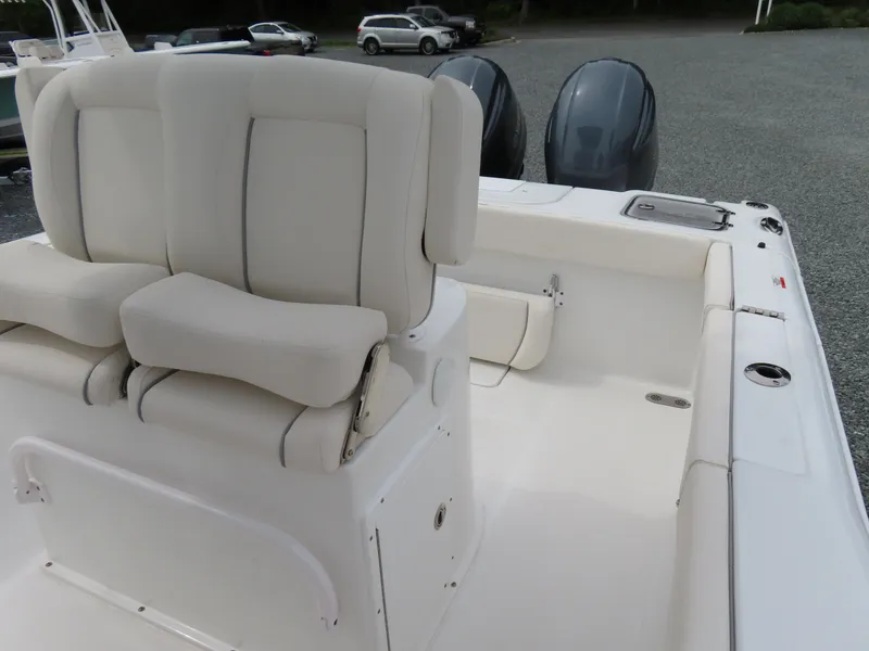 Slide: The Image of 2023 Sea Hunt Gamefish 25 boat interior with dual engines and cushioned seating. - 22
