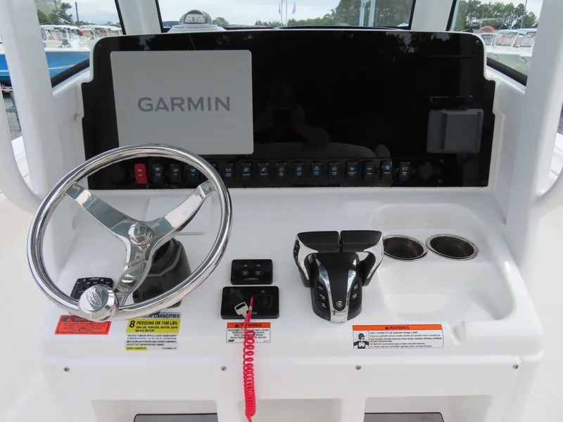 Slide: The Image of 2023 Sea Hunt Gamefish 25 dashboard with Garmin display and steering wheel. - 25