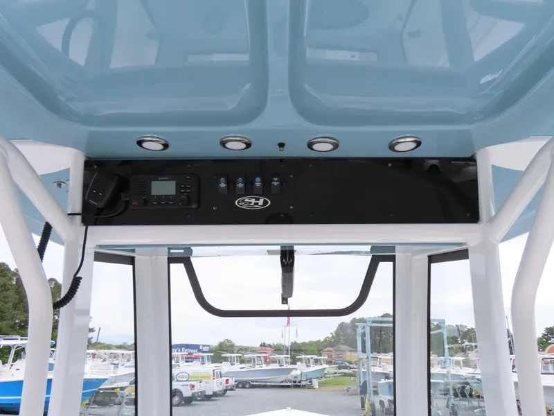 Slide: The Image of 2023 Sea Hunt Gamefish 25 boat console with controls and overhead panel. - 28