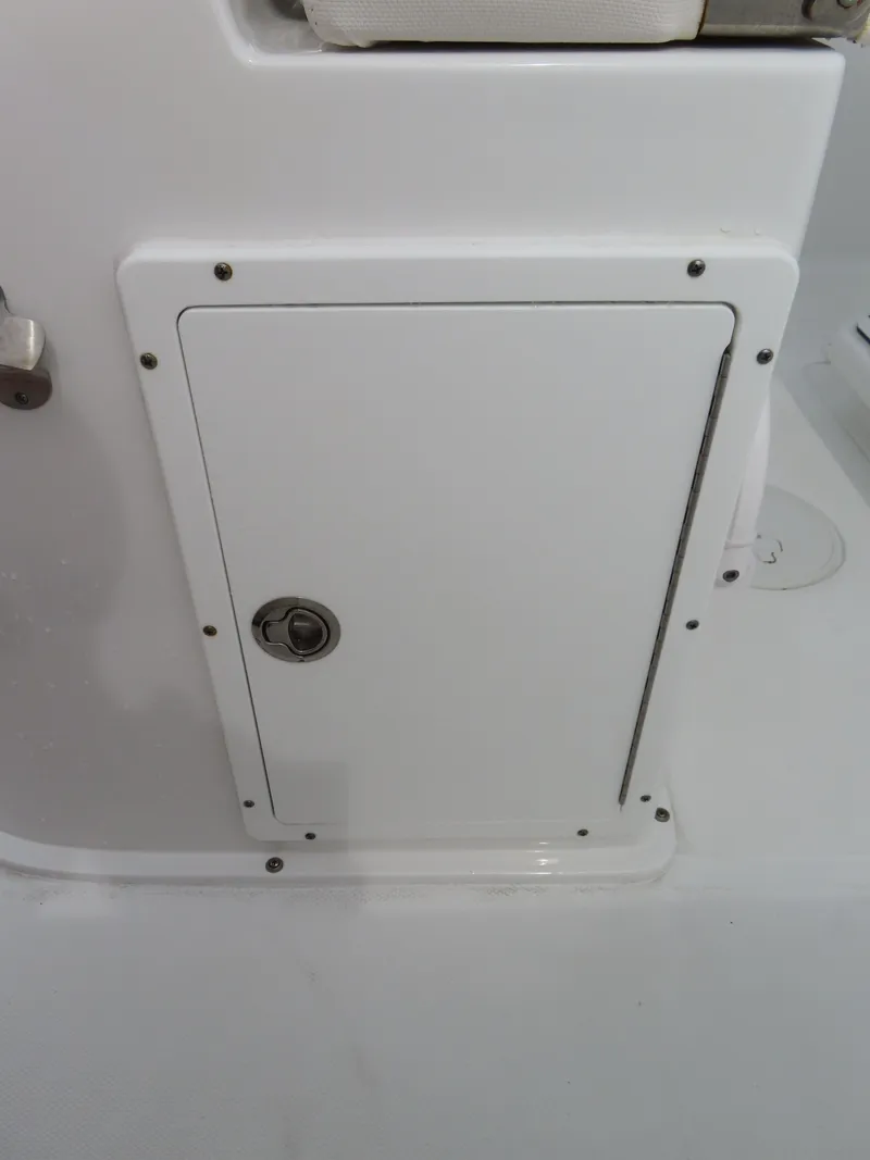 Slide: The Image of 2023 Sea Hunt Gamefish 25 boat storage compartment with secure latch. - 32