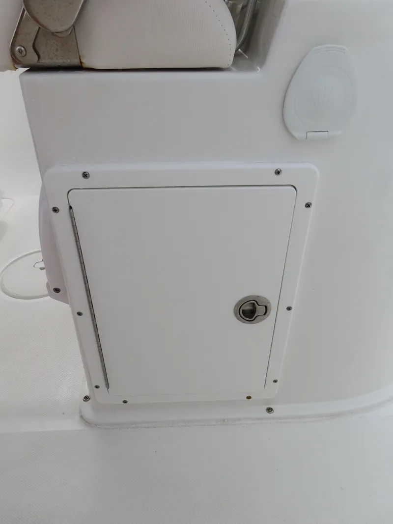 Slide: The Image of 2023 Sea Hunt Gamefish 25 boat storage compartment with secure latch. - 34