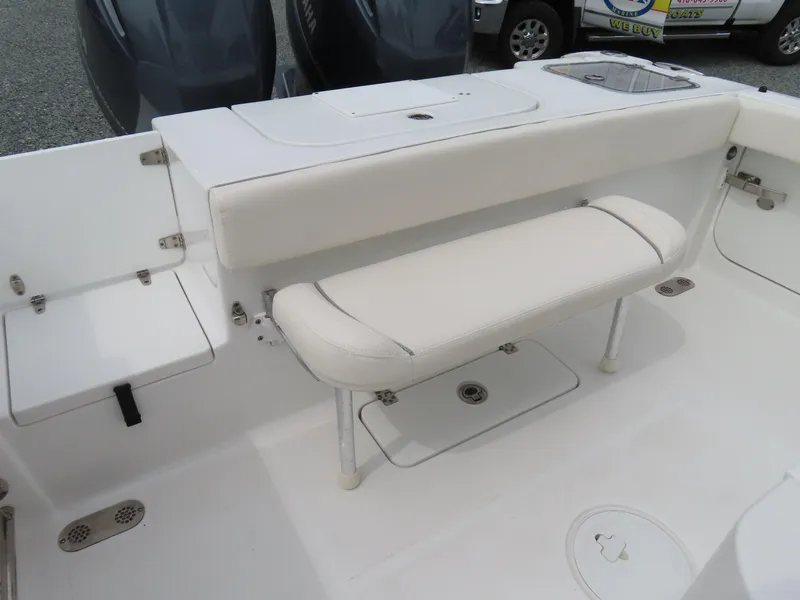 Slide: The Image of 2023 Sea Hunt Gamefish 25 boat interior with white seating and storage compartments. - 36