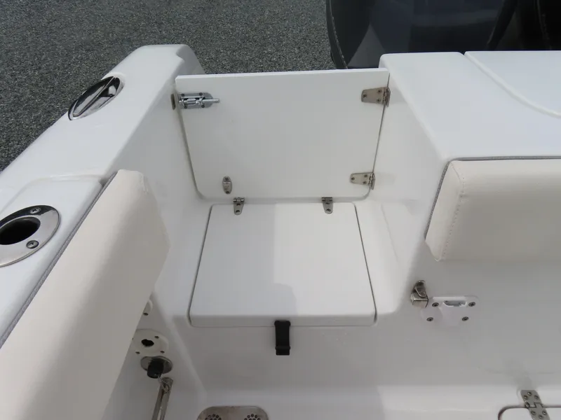 Slide: The Image of 2023 Sea Hunt Gamefish 25 boat interior with white seating and storage compartment. - 39