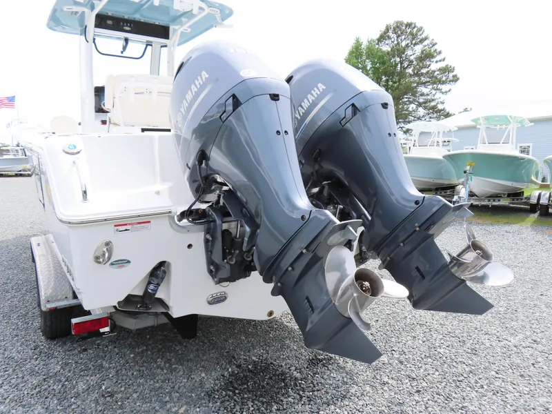 Slide: The Image of 2023 Sea Hunt Gamefish 25 with dual Yamaha outboard motors, parked on gravel. - 4
