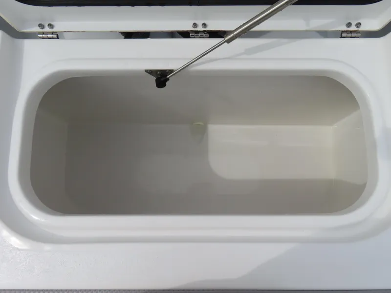 Slide: The Image of 2023 Sea Hunt Gamefish 25 boat storage compartment, open lid, white interior. - 42