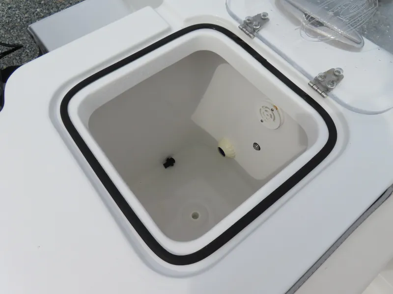 Slide: The Image of 2023 Sea Hunt Gamefish 25 livewell, open lid, white interior, marine equipment. - 44