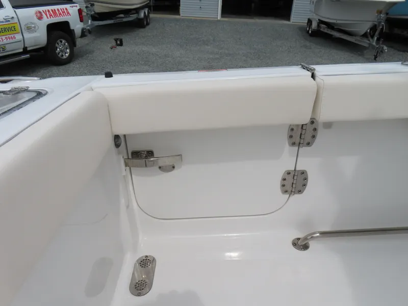 Slide: The Image of 2023 Sea Hunt Gamefish 25 boat interior, featuring white seating and stainless steel fixtures. - 45