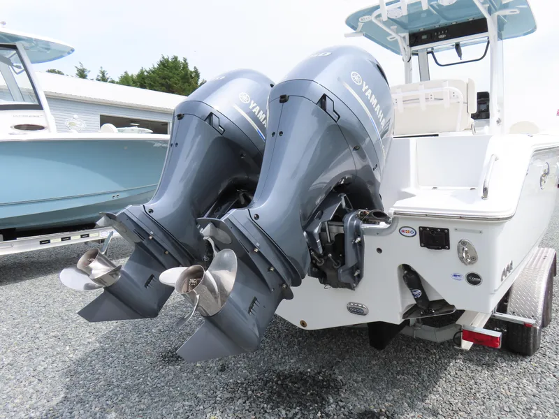 Slide: The Image of 2023 Sea Hunt Gamefish 25 with dual Yamaha outboard motors, parked on gravel. - 5