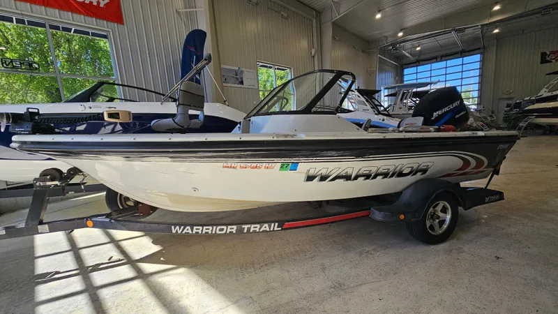 Slide: The Image of Boat in showroom: 2000 Warrior 1898 DC on trailer, side view. - 1