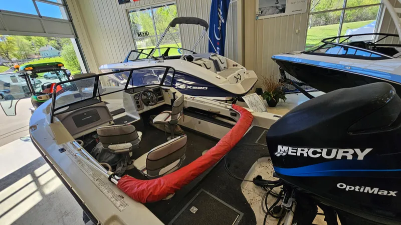 Slide: The Image of Showroom display of a 2000 Warrior 1898 DC boat with Mercury OptiMax engine. - 10