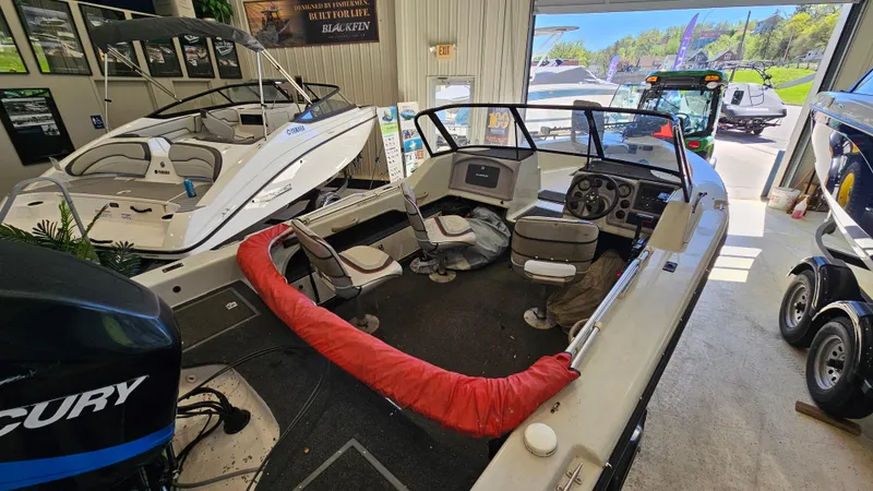 Slide: The Image of Boat showroom featuring a 2000 Warrior 1898 DC model with Mercury engine. - 11