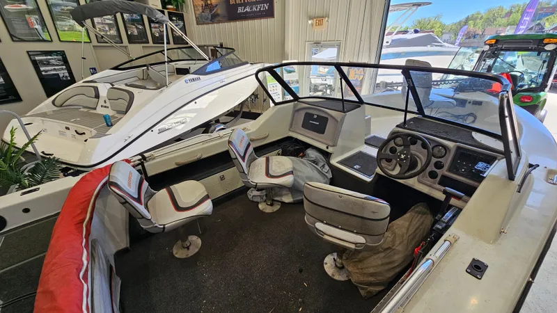 Slide: The Image of Interior of a 2000 Warrior 1898 DC boat with seating and control panel. - 12