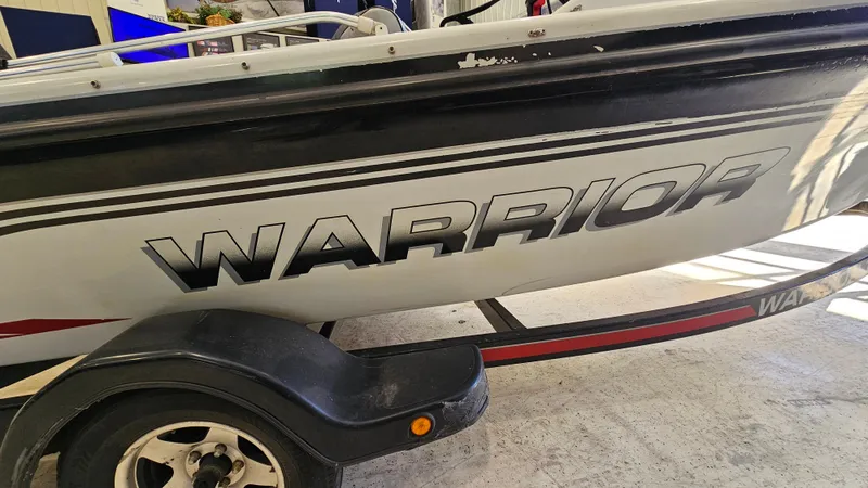 Slide: The Image of Boat trailer with "Warrior 1898 DC" branding, model year 2000, in a garage setting. - 15