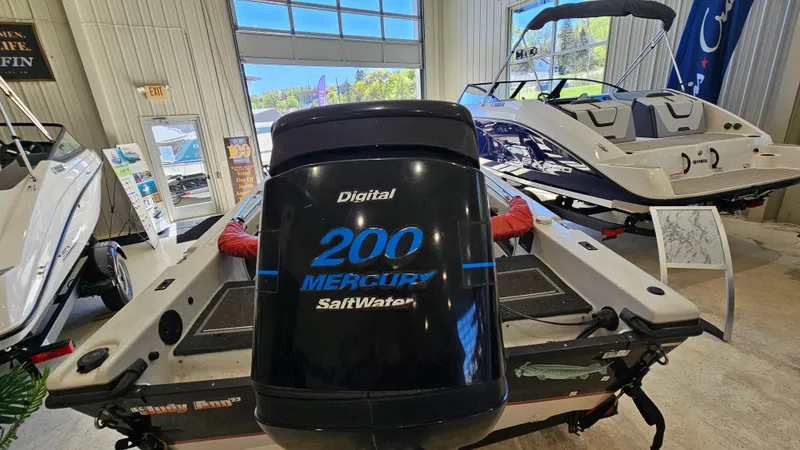 Slide: The Image of Boat showroom featuring a 2000 Warrior 1898 DC with Mercury 200 SaltWater engine. - 18